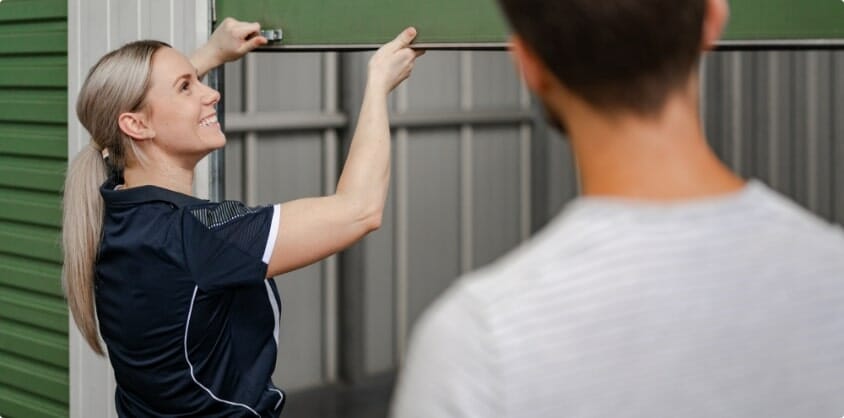 A Loxon Storage employee opening a storage unit