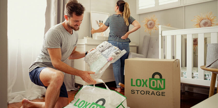 People packing items into a Loxon Storage box