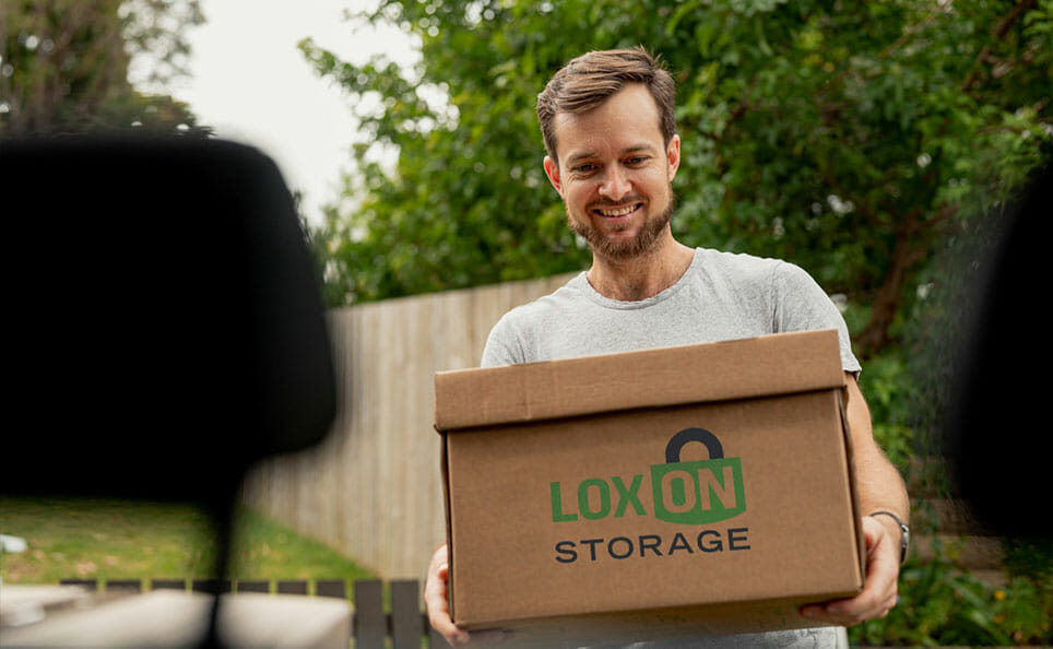 Person carrying a Loxon Storage box