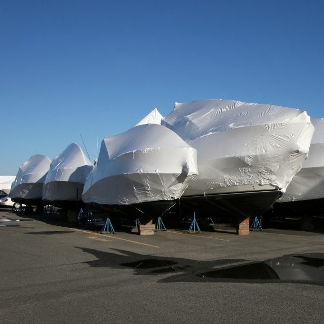 covered boats sitting in dry boat storage
